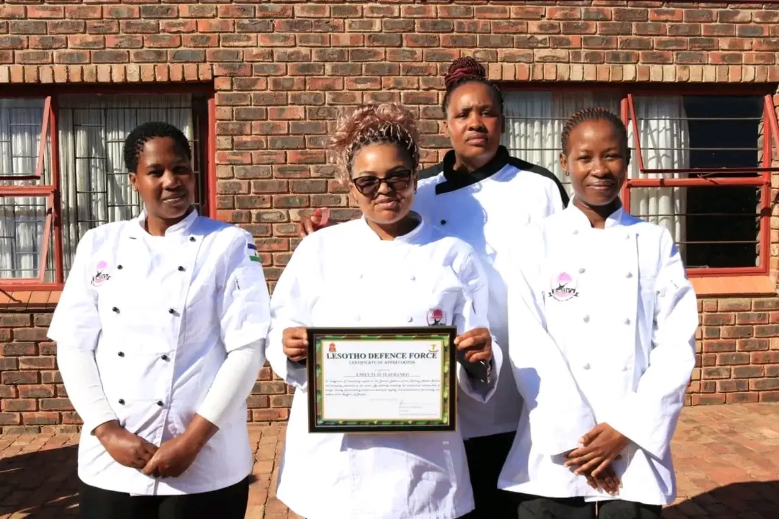 Emily's Kitchen chefs celebrating a certificate of appreciation